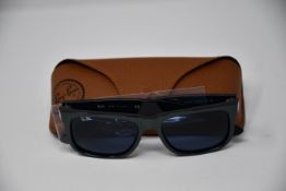 A pair of as new Ray Ban sunglasses.