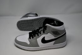 A pair of as new Nike Air Jordan 1 mid trainers (UK 9).