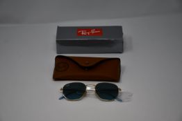 A pair of as new Ray Ban sunglasses.