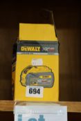 One boxed Dewalt lithium ion XR flex volt battery (18 volt).