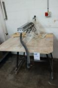 A pre-owned Dewalt cross-cut saw and bench.