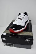 A pair of as new Nike Air Jordan 11 Retro low trainers (UK 9.5).