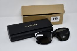 A pair of Burberry sunglasses with case and box.