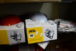 One Petzl Strato lightweight helmet in red, one Petzl Vertex ventilated helmet in white and one