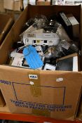 A box of assorted as new and pre-owned small electrical items and accessories.
