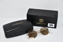 A pair of as new Versace sunglasses.
