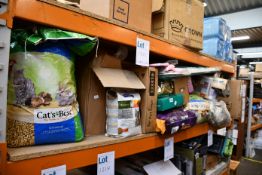 A quantity of miscellaneous pet related items to include pet food, litter pellets and cages.