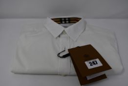 A Burberry long sleeve shirt with tags (XS).