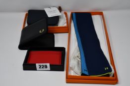 An as new Hermes tie, a pre-owned Hermes purse (Excellent condition with box), an as new Fred