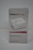 Three boxed as new PerfectDry LUX dry & disinfect Hearing Aids.