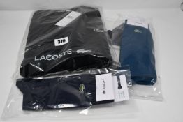 An as new Lacoste sweatshirt in black (US S/FR 3 - RRP £90) together with assorted Lacoste socks.