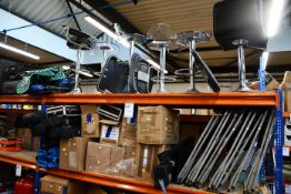 A shelf of miscellaneous items to include chairs, display stands, trolley, umbrellas and walking