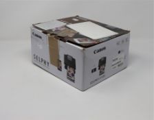 A boxed as new Canon SELPHY CP1300 Compact wireless photo printer (superficial damage to box).