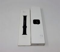 A boxed as new Apple Watch Series 5 in Space Gray and a boxed as new Apple Watch Sport Band in Black