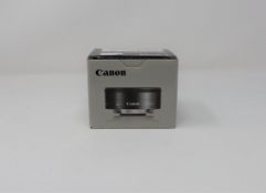 A boxed as new Canon EF-M 22mm f/2.0 STM lens.