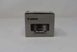A boxed as new Canon EF-M 22mm f/2.0 STM lens.