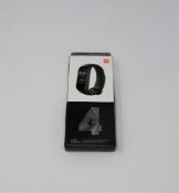 A boxed as new Xiaomi Mi Smart Band 4 in Black (Model: XMSH07HM) (Box sealed, some cosmetic damage