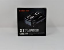 A boxed as new Godox X1T-O TTL Wireless Flash Trigger for Olympus and Panasonic.