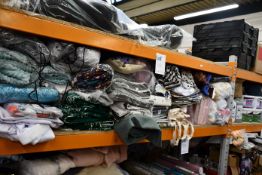A quantity of miscellaneous fabrics, bedding, cushion covers and related items.