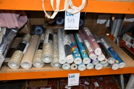A quantity of wallpaper in various designs and lengths.