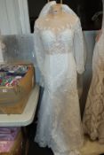 One decorative wedding dress with clip on outer skirt.