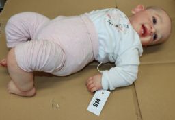 A pre-owned realistic life size baby doll.