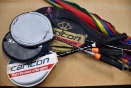 Six tennis/badminton rackets and an umbrella.