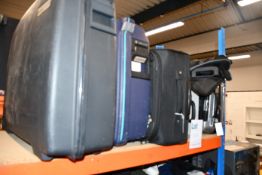 five empty suitcases/holdalls and a storage box.