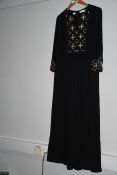 One pre-owned Tory Burch black tunic with strass decorations on the front. Size 8.