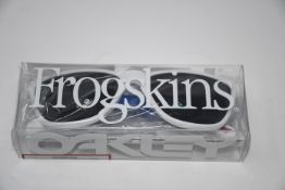 One boxed Oakley Frogskins 35th anniversary. Frame: polished white. Lens: prizm grey. (Damaged
