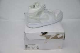 A pair of women's as new Nike Air Jordan 1 Mid sneakers (UK 7).