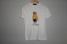 Two as new classic Ralph Lauren white t-shirt with bear motif to the front (XS, XL).