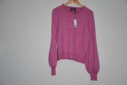 An as new Wyse of London pink jumper with frill round neck and balloon sleeves (Size 1).