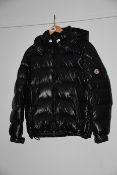 One pre-owned Moncler black feather down jacked size 3 (Sleeves and pockets buttons slightly