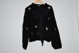 An as new Wyse of London black sequined star cardigan with a ribbon bow and balloon sleeves (Size
