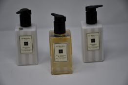 Two Jo Malone Pomegranate Noir body & hand lotion (250ml) and one Jo Malone Black Cedarwood &