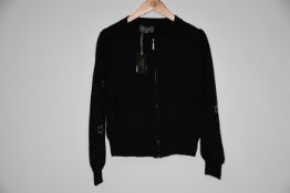 An as new Wyse of London black zip up balloon sleeved cardigan with star details and front