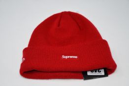 One as new Supreme New Era S Logo Beanie red.