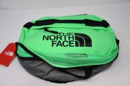 An as new The North Face base camp small duffel travel bag in green.