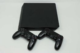 A pre-owned Sony Playstation 4 PS4 Slim CUH-2016A (Powers on but not further tested) and two Sony
