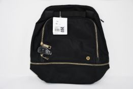 One as new Lululemon City Adventurer Backpack Mini (Colour: black/gold. Model: LW9CR9S).