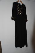 One pre-owned Tory Burch black tunic with strass decorations on the front. Size 8.