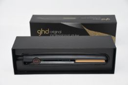 A pair of as new GHD original professional styler hair straighteners.
