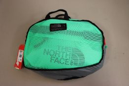 An as new The North Face base camp small duffel travel bag in green.