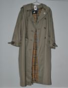 One pre-owned Burberry trench coat (size unknown).