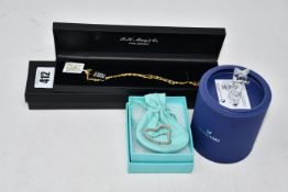 An as new R.H.Macy & Co 14k gold chain with J and B initial pendants together with a Swarovski