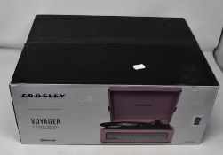 One boxed as new Crosley Voyager three speed portable turntable.