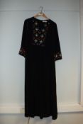 One pre-owned Tory Burch black tunic with strass decorations on the front. Size 8.