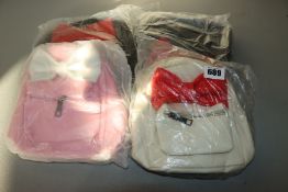 Two as new The Bow Mini Backpack black with red bow. One as new The Bow Mini Backpack white with red