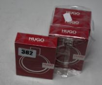 Four boxed as new Hugo Boss Woman eau de parfum (50ml).